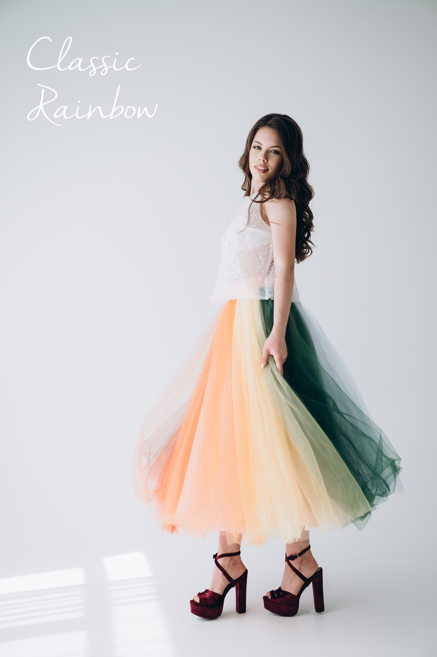 Young woman wearing a midi classic rainbow skirt at a Pride party · colourful LGBT wedding guest or festival outfit