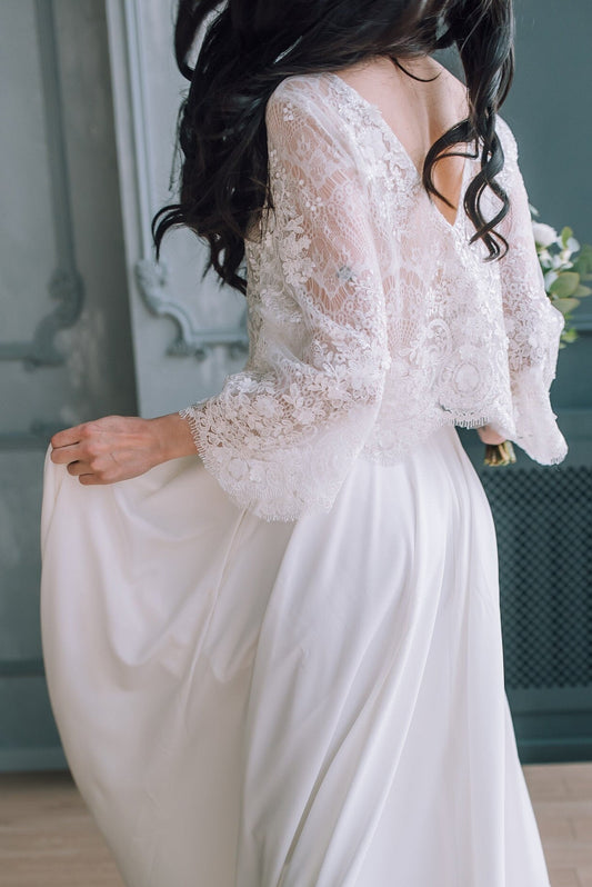 Back view of 3/4 sleeve lace bridal top paired with an ivory crepe skirt, showing button detailing and delicate floral lace texture.