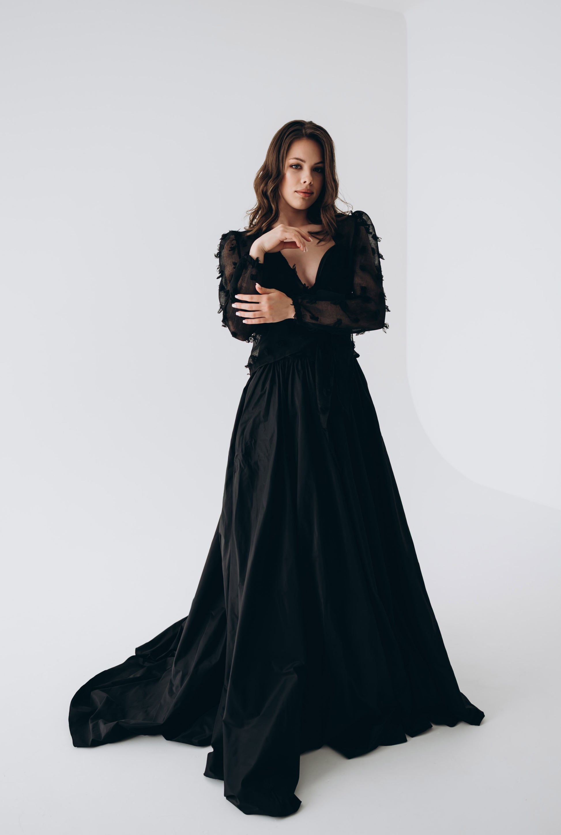 Side view of black skirt with dramatic train and sculptural silhouette