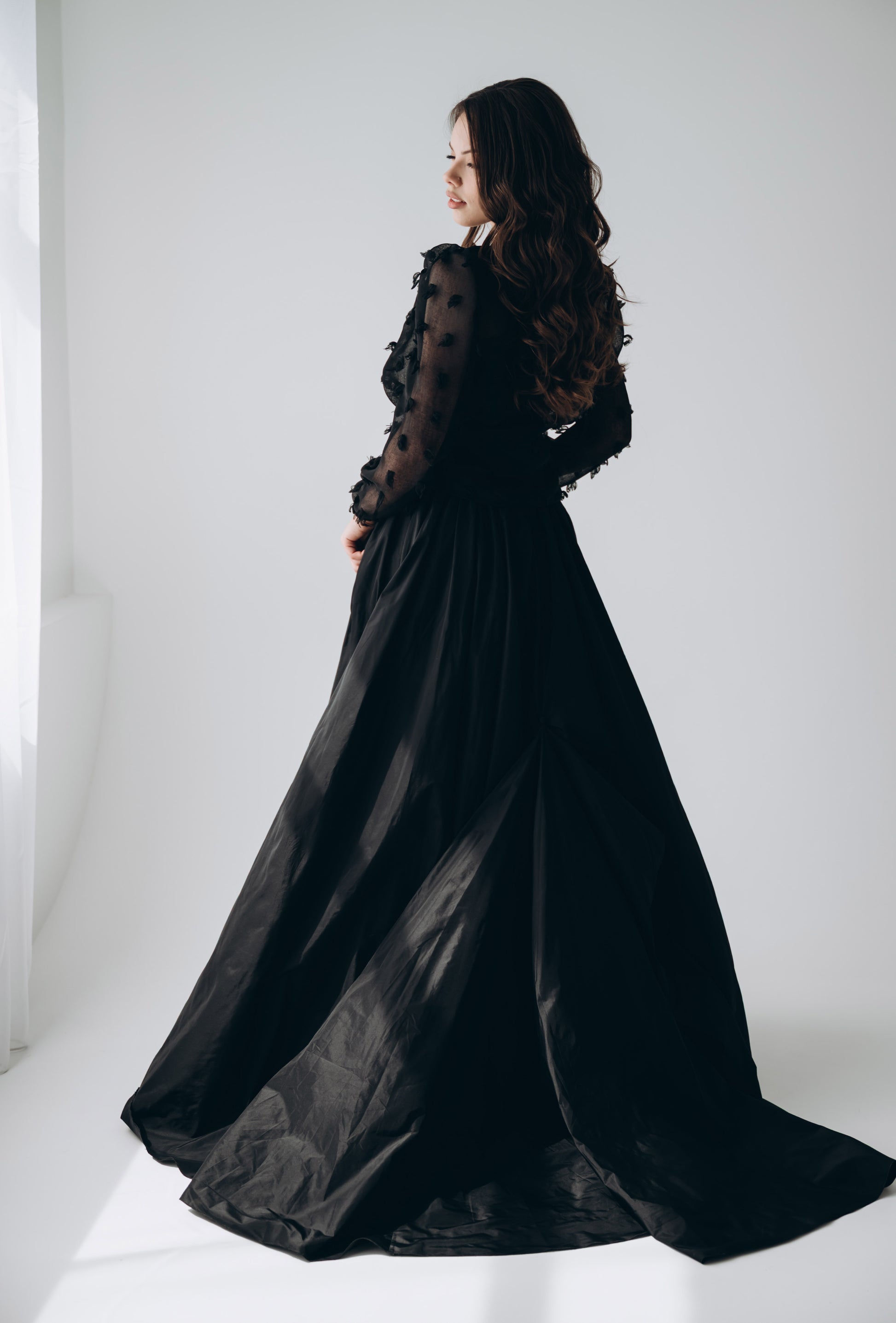 Black taffeta bridal skirt paired with sheer corset top for alternative wedding look