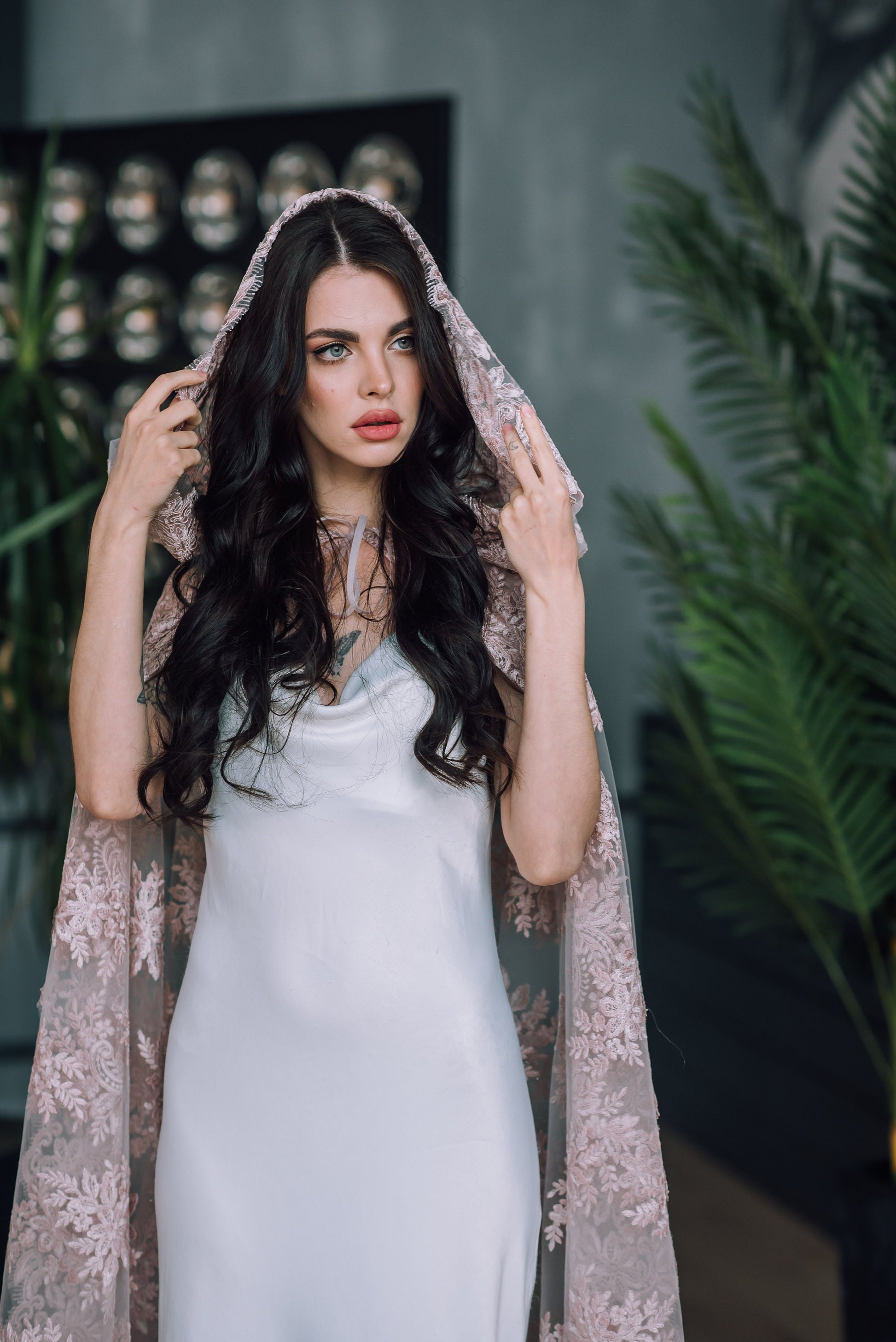 Blush pink guipure lace hooded veil styled with white wedding gown