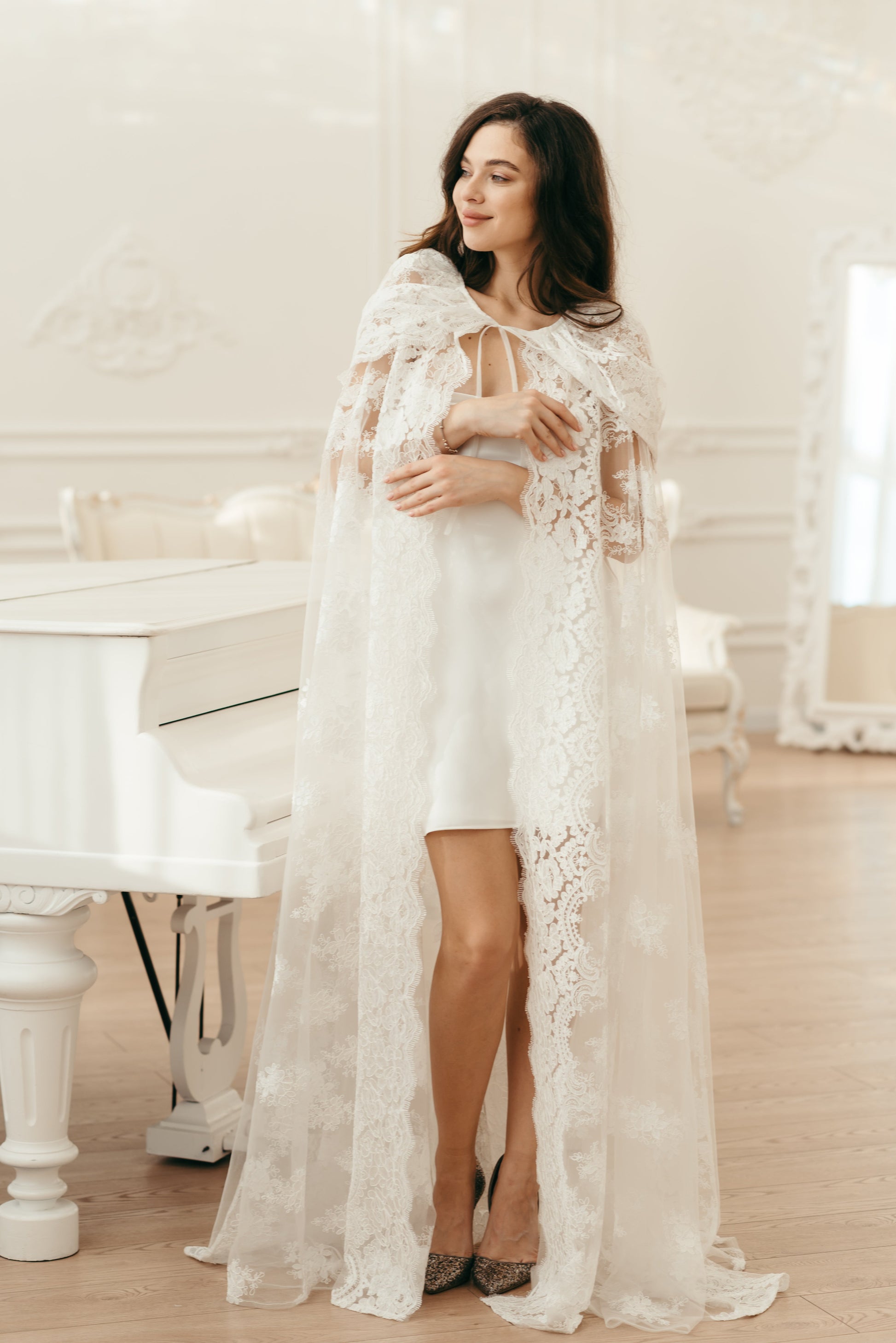 Long ivory lace hooded veil worn over sheer gown with floral detail