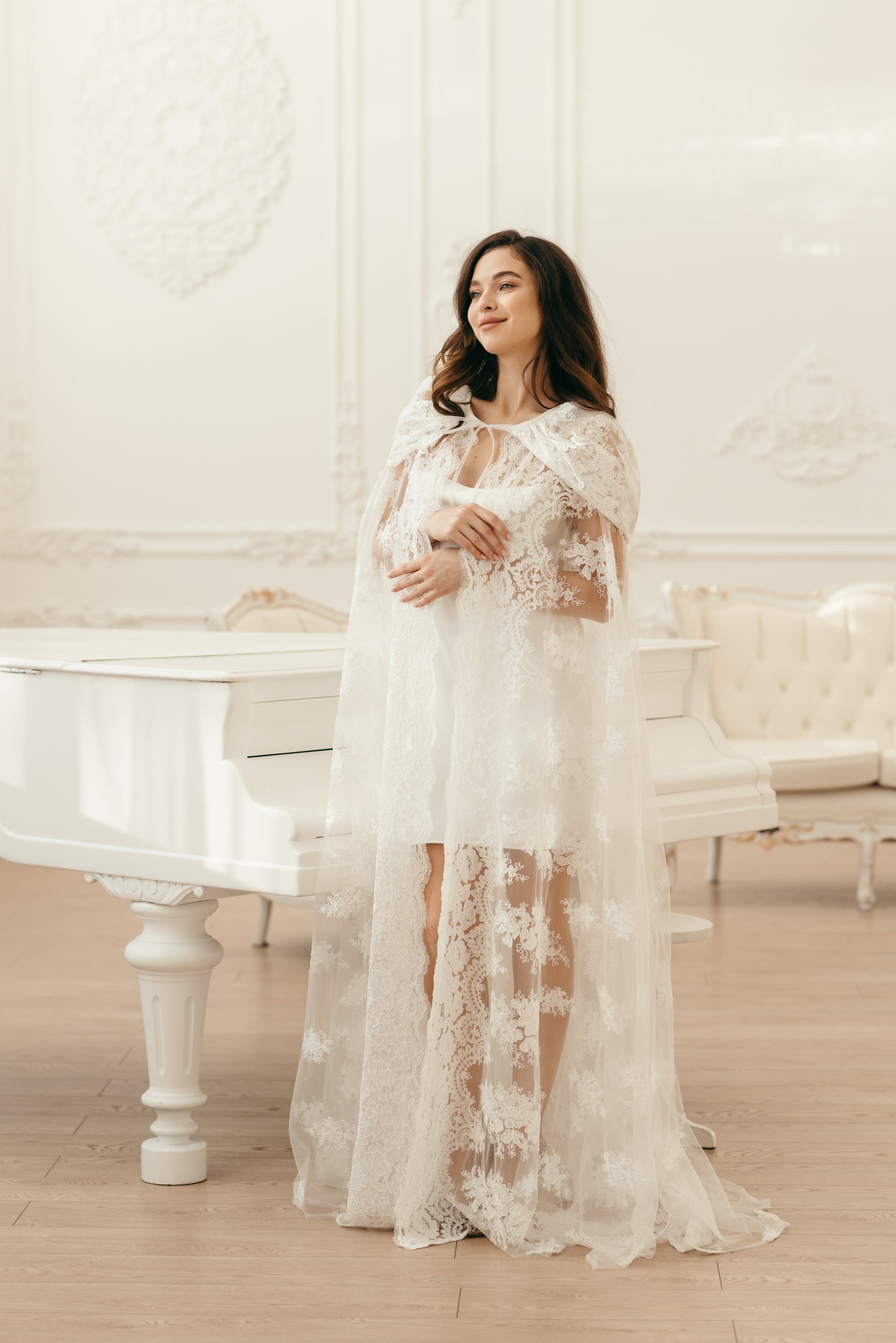 Ivory floral lace cape with hood, styled for elegant bridal ceremony