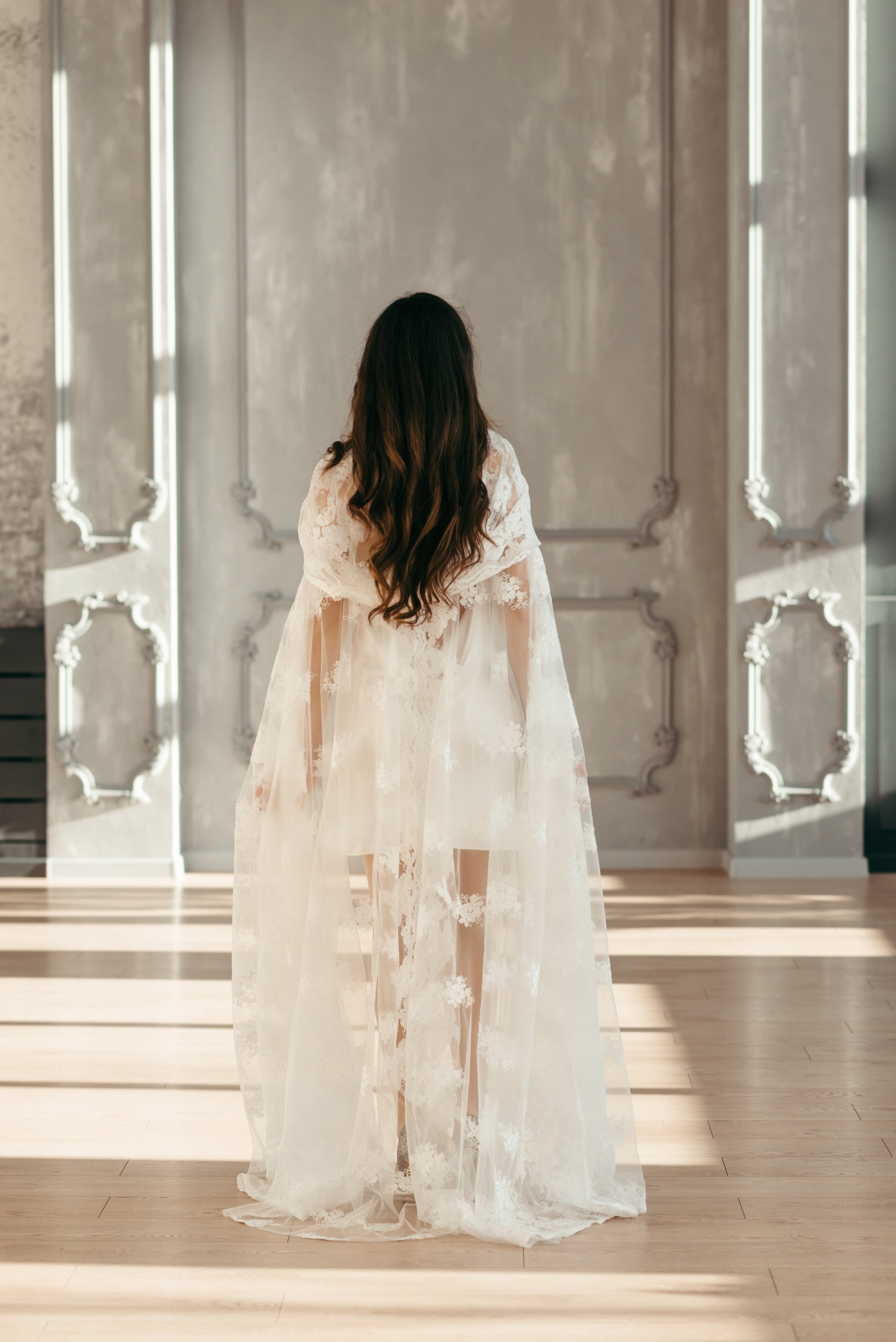 Back view of ivory lace wedding cape with long train