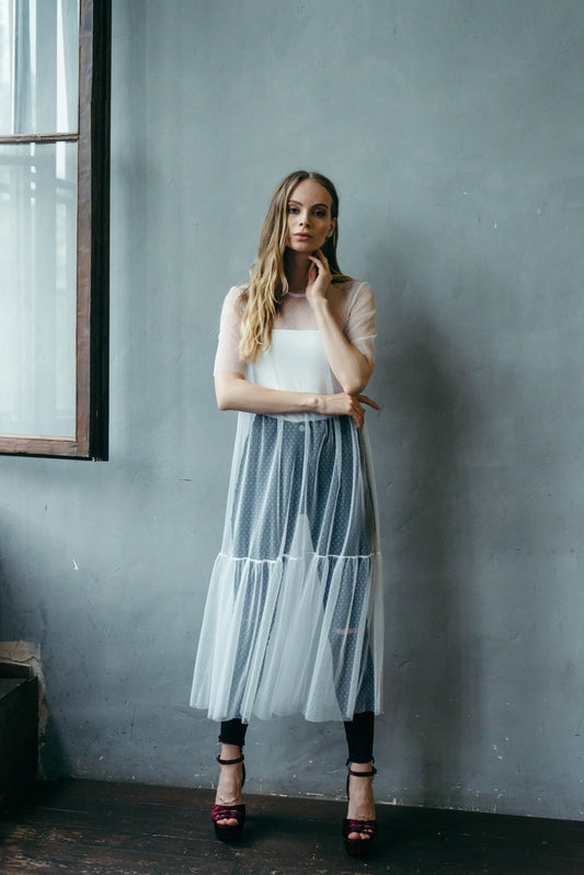 White polka dot tulle midi dress, model in front view pose.