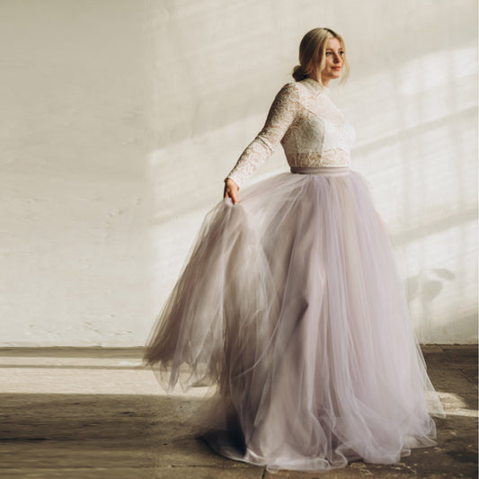 Bride twirling in lilac and grey ombre tulle skirt with long sleeve top – romantic bridal separates for evening weddings.