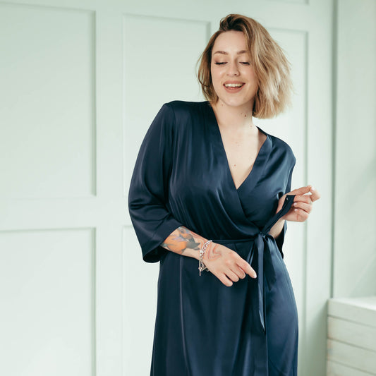 Woman modeling long navy satin kimono robe, semi-matte luxury satin.
