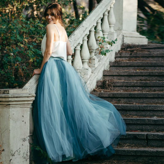 Bride standing in colourful deep sea blue ombré tulle skirt with embroidered top