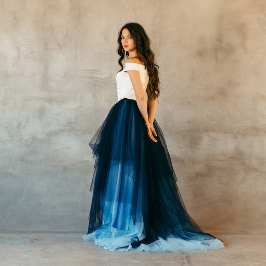 Bride standing in blue ombré tulle skirt for beach wedding or destination ceremony.