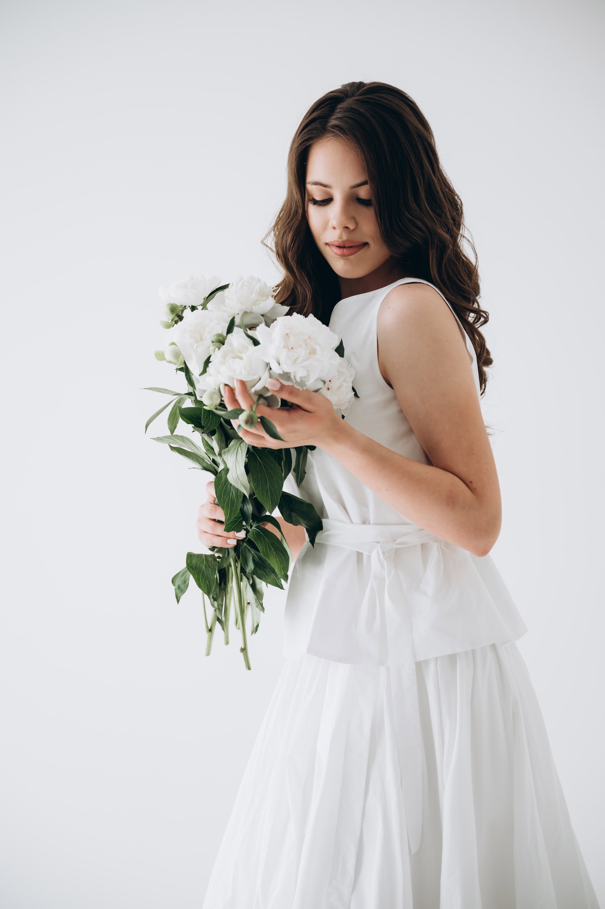 Full-length bridal portrait in white taffeta skirt and corset top
