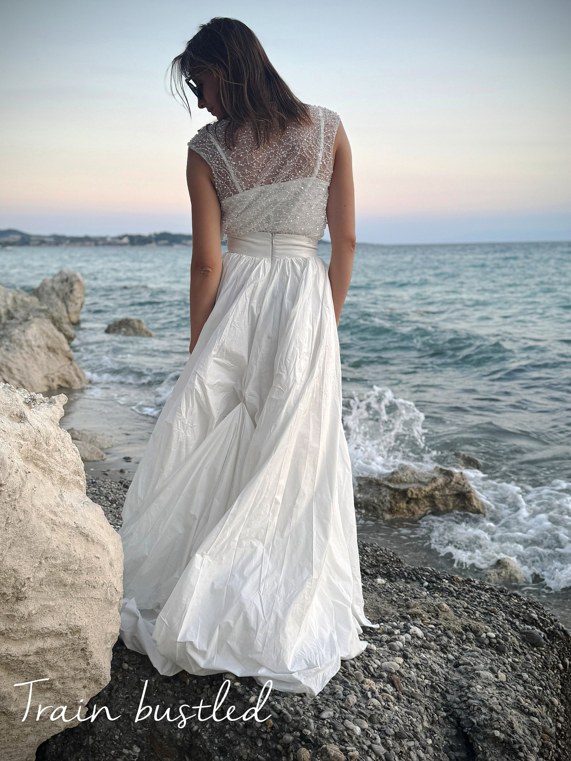 White taffeta skirt with train, styled on rocky coastline for beach wedding shoot