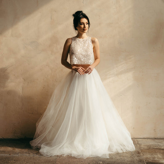 Sleeveless sparkling bridal top paired with an ivory tulle bridal skirt