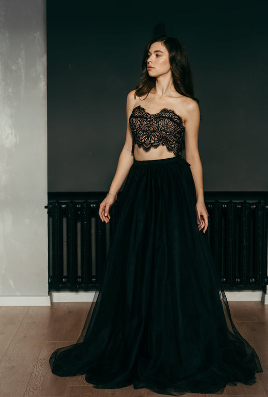 Bride is wearing a black tulle wedding skirt paired with a gothic style corset