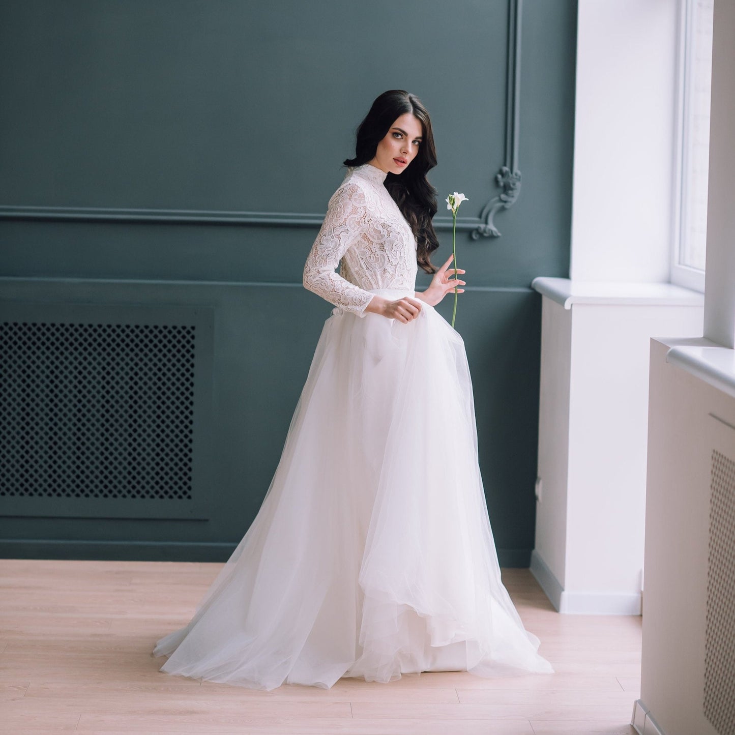  Side profile of ivory lace top paired with a soft off-white tulle skirt for a graceful, layered bridal silhouette.