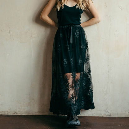 Full-length view of black lace skirt showcasing intricate corded lace with a see-through design, perfect for gothic bridal looks, festivals, or party outfits.