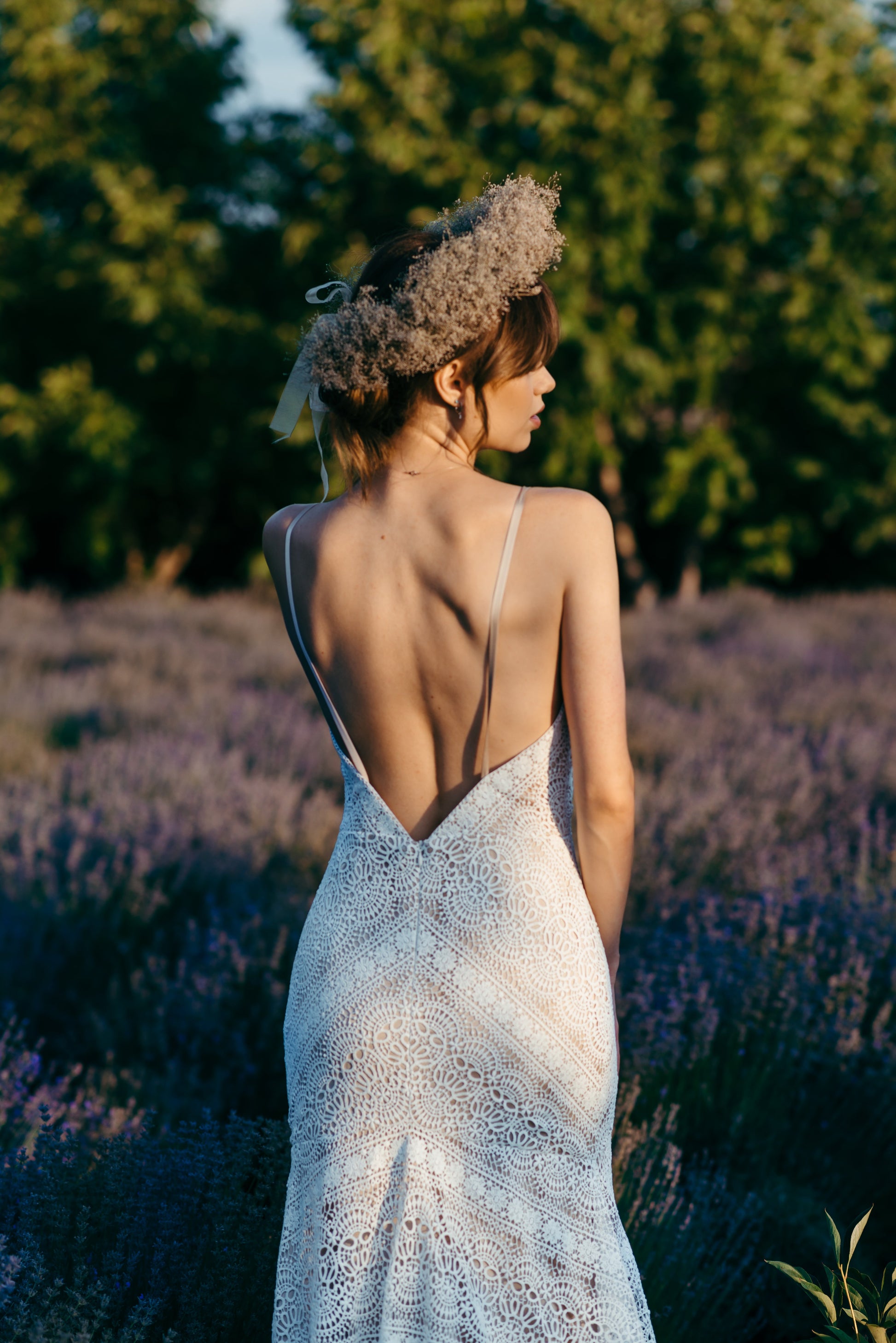 Liv macramé lace wedding dress with train photographed in natural setting
