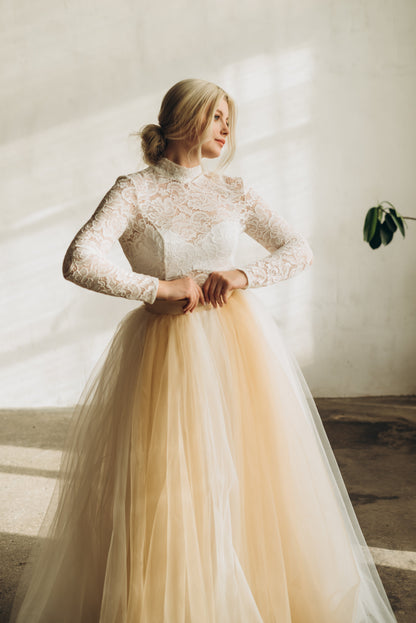 Bride wearing champagne and ivory ombre tulle skirt with fitted long sleeve top – traditional wedding skirt for church ceremonies.