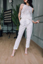 Bridal look featuring ivory lace top paired with white tailored trousers for modern wedding styling