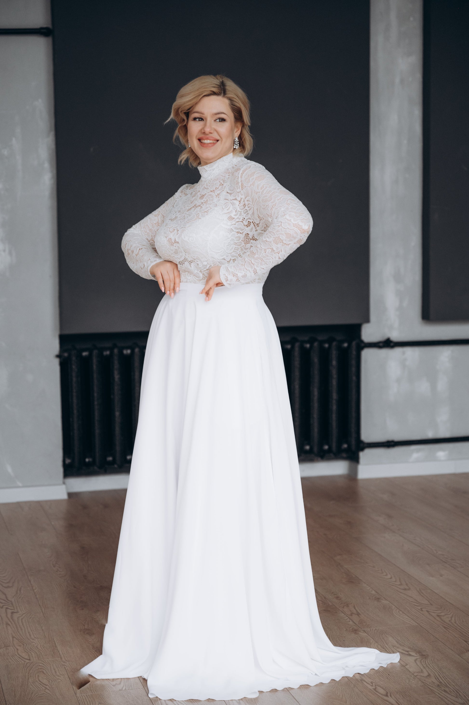 Bride wearing pure white bridal top and white satin wedding skirt