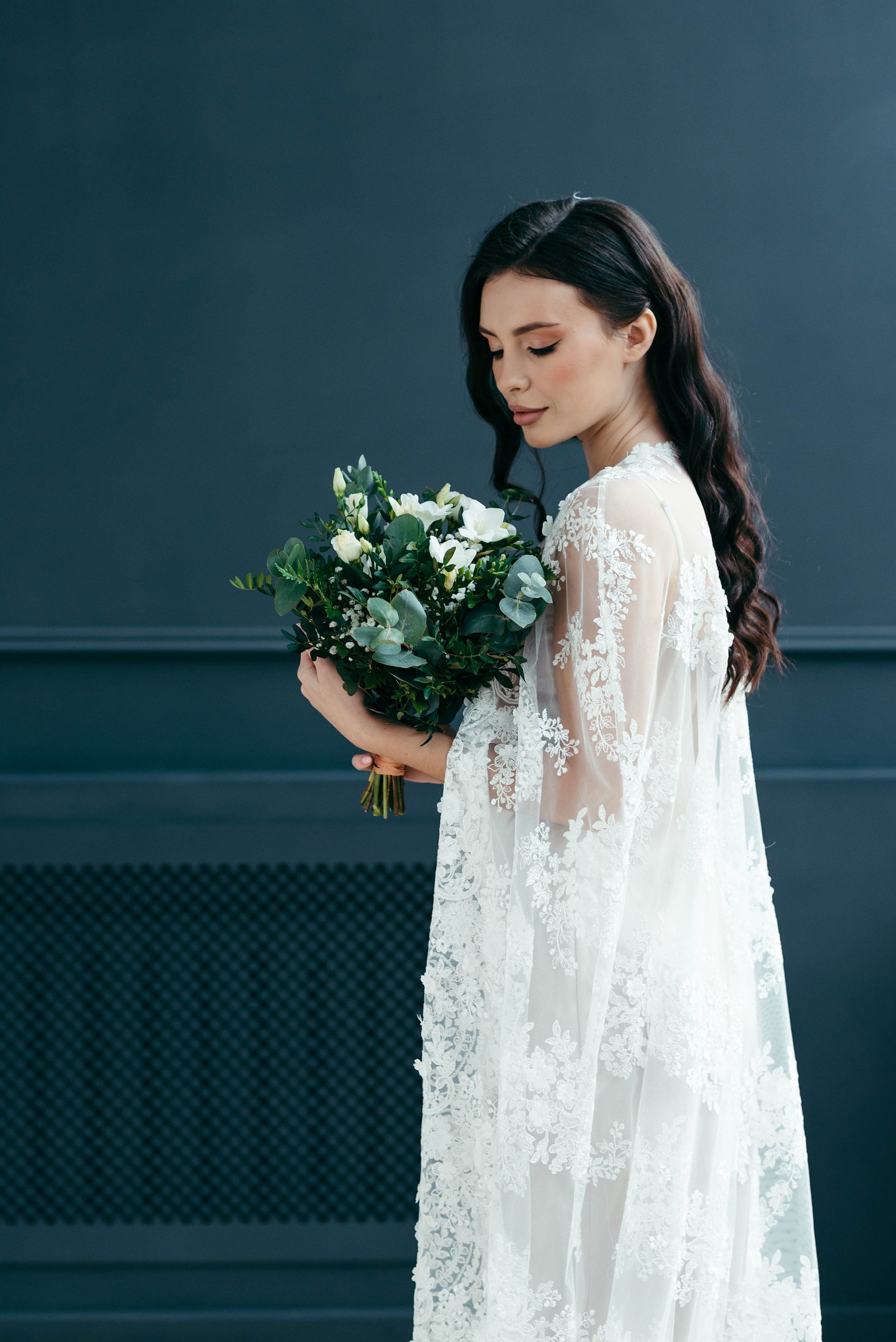 Romantic bridal cape in floral corded lace, perfect for ceremonies, portraits, or reception styling.