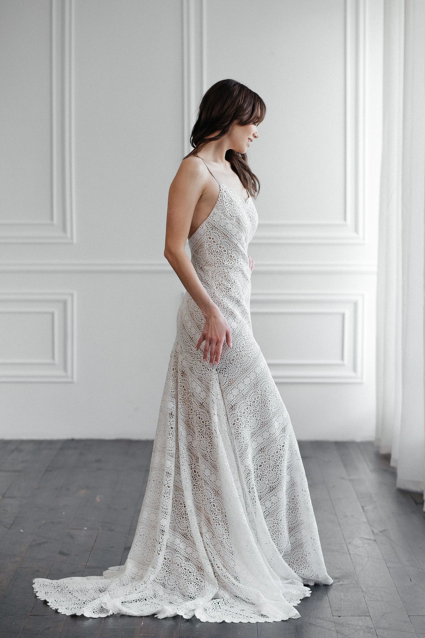 Side view of Liv ivory macramé lace wedding dress with fit and flare mermaid shape