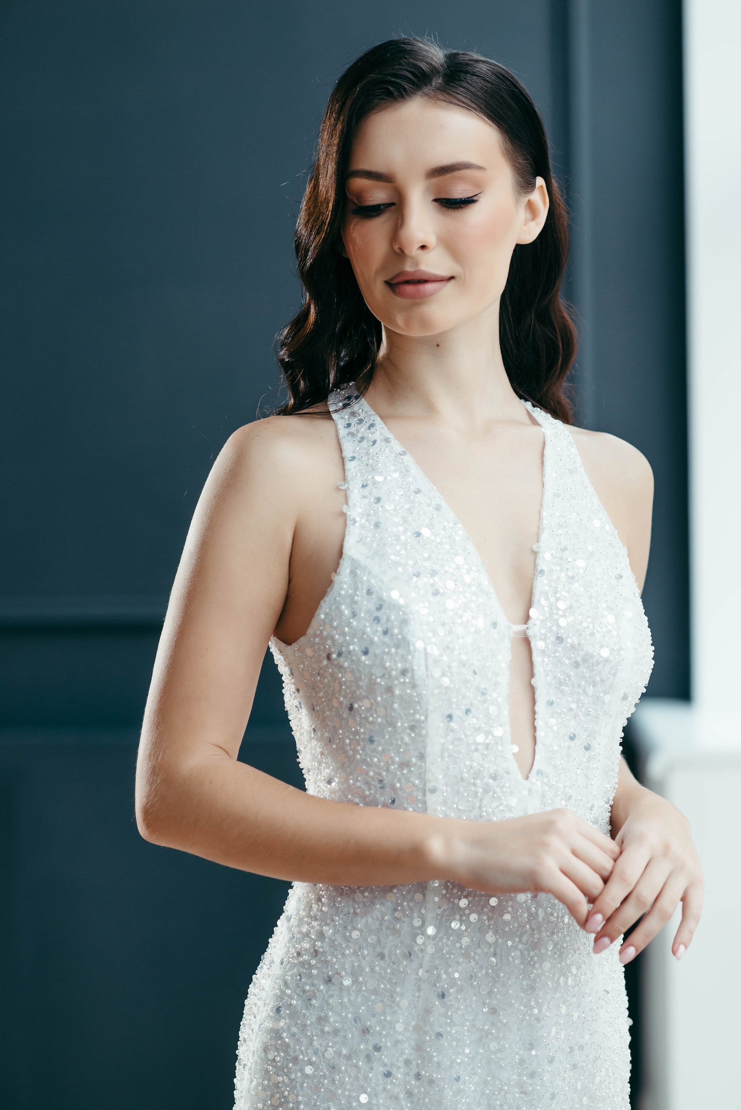 Fitted ivory sequin wedding dress close-up