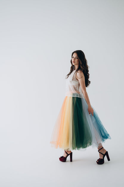 Woman wearing a colorful tulle wedding skirt on a white background