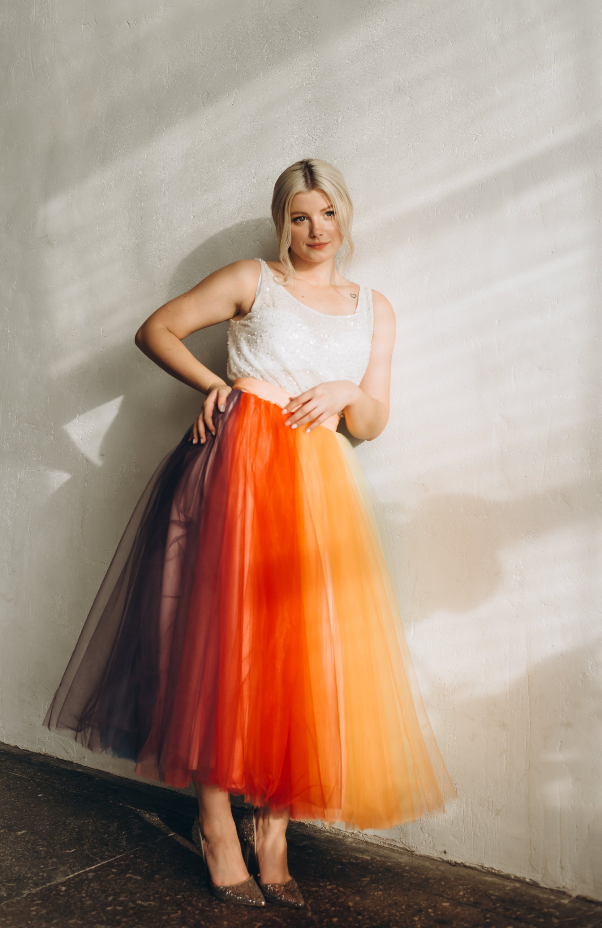Bride wearing a colorful rainbow tulle skirt paired with a beaded sleeveless top