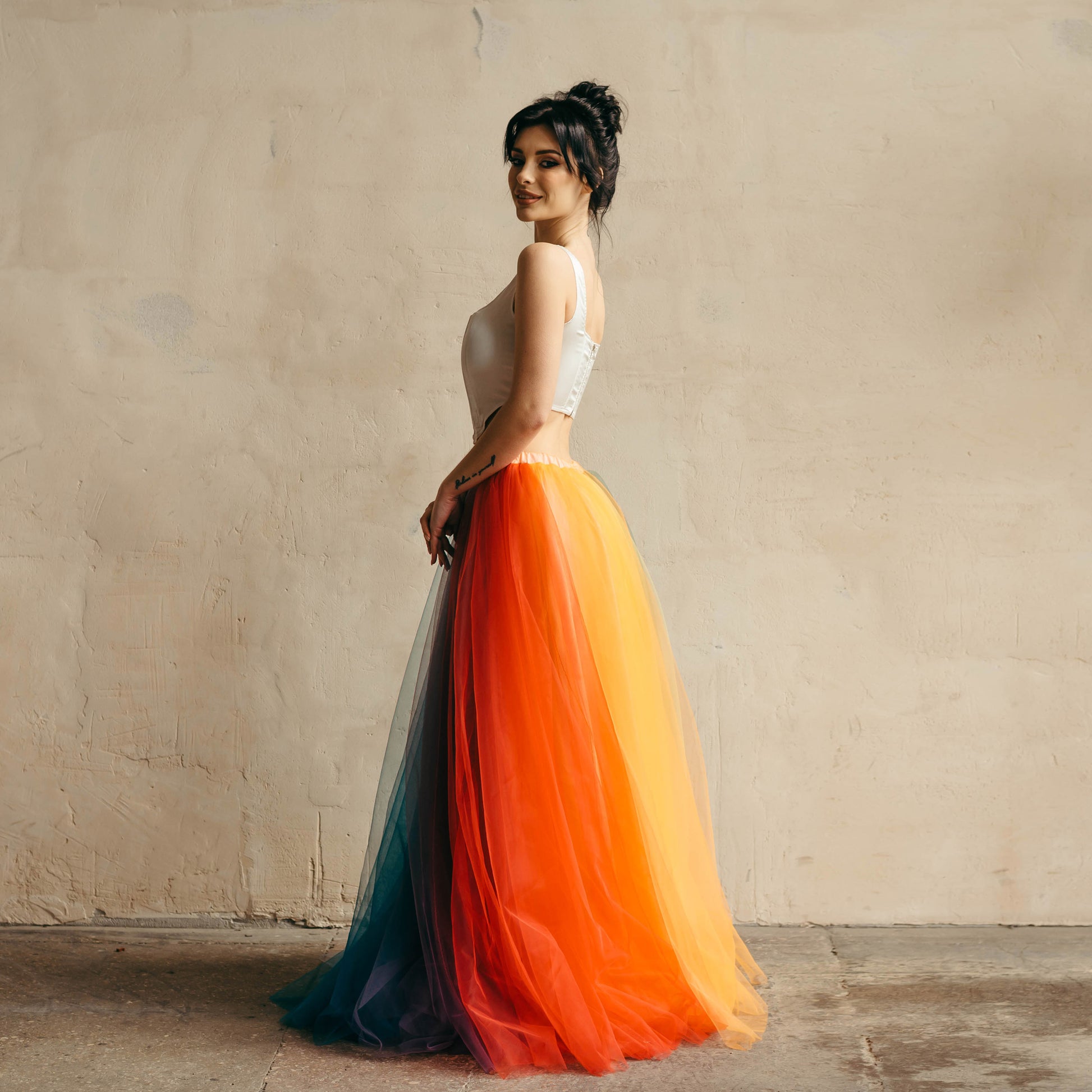 Model wearing a Classic Rainbow tulle skirt in vibrant tones, styled for an LGBTQ+ or Pride wedding look.