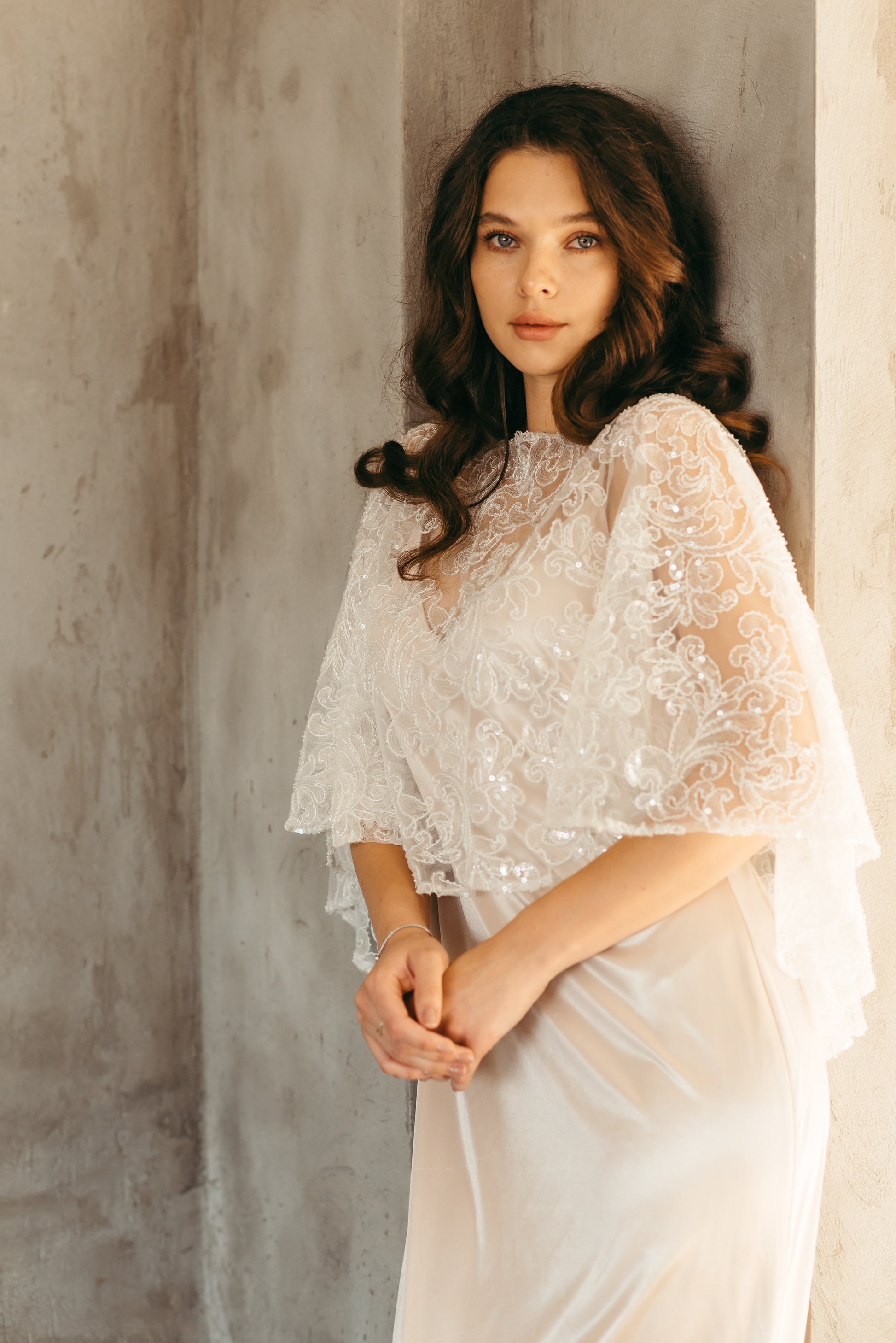 Bride wearing beaded sequined capelet, close up portrait