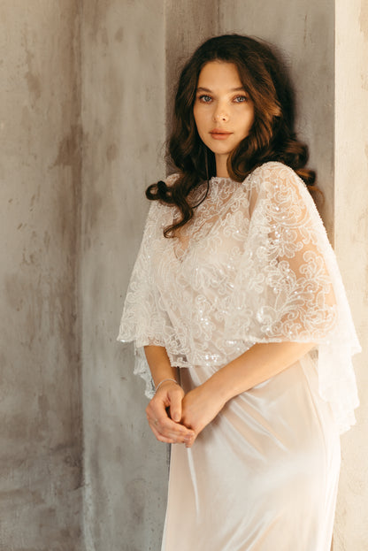 Bride wearing beaded sequined capelet, close up portrait