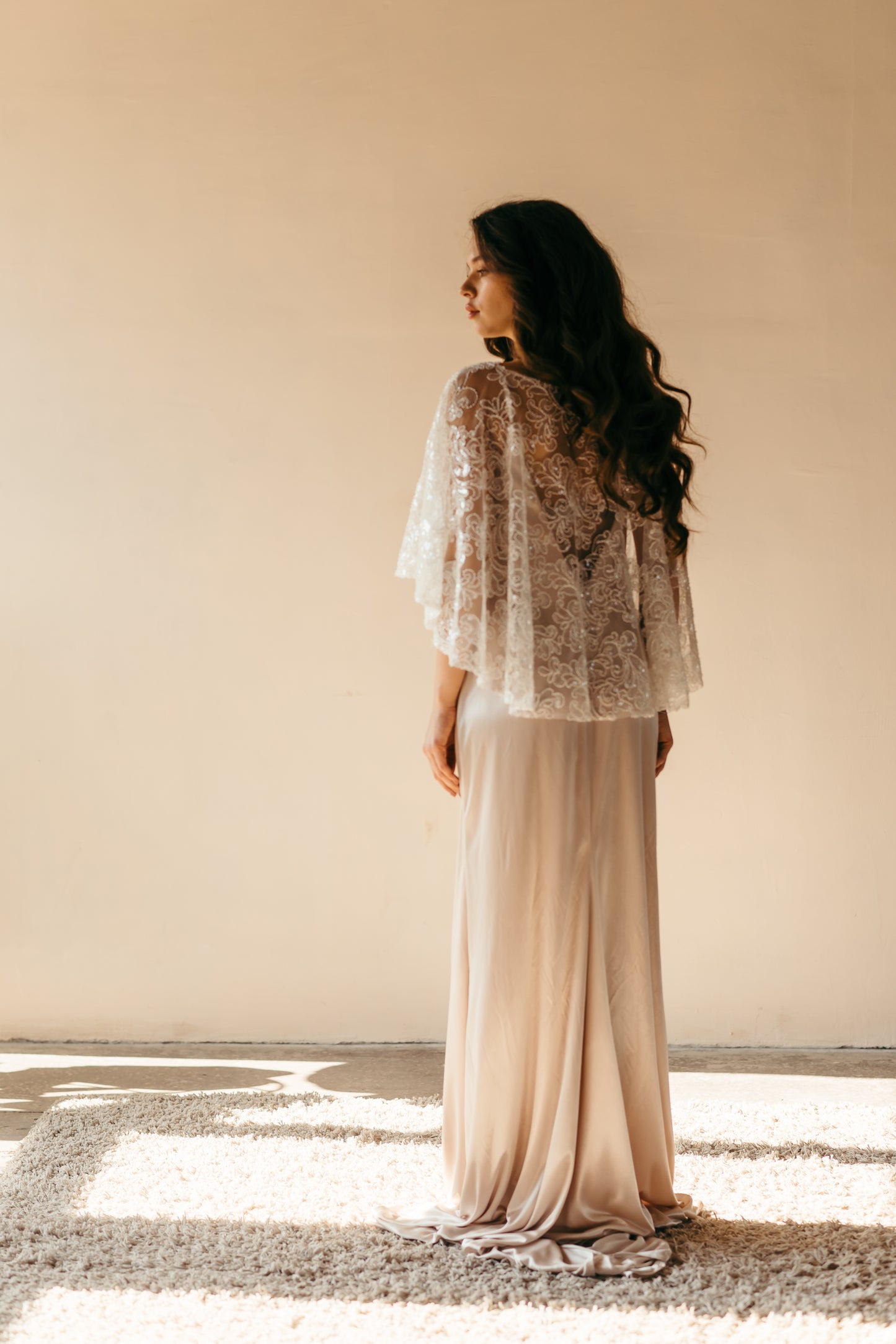 Bride wearing beaded sequined capelet, side profile