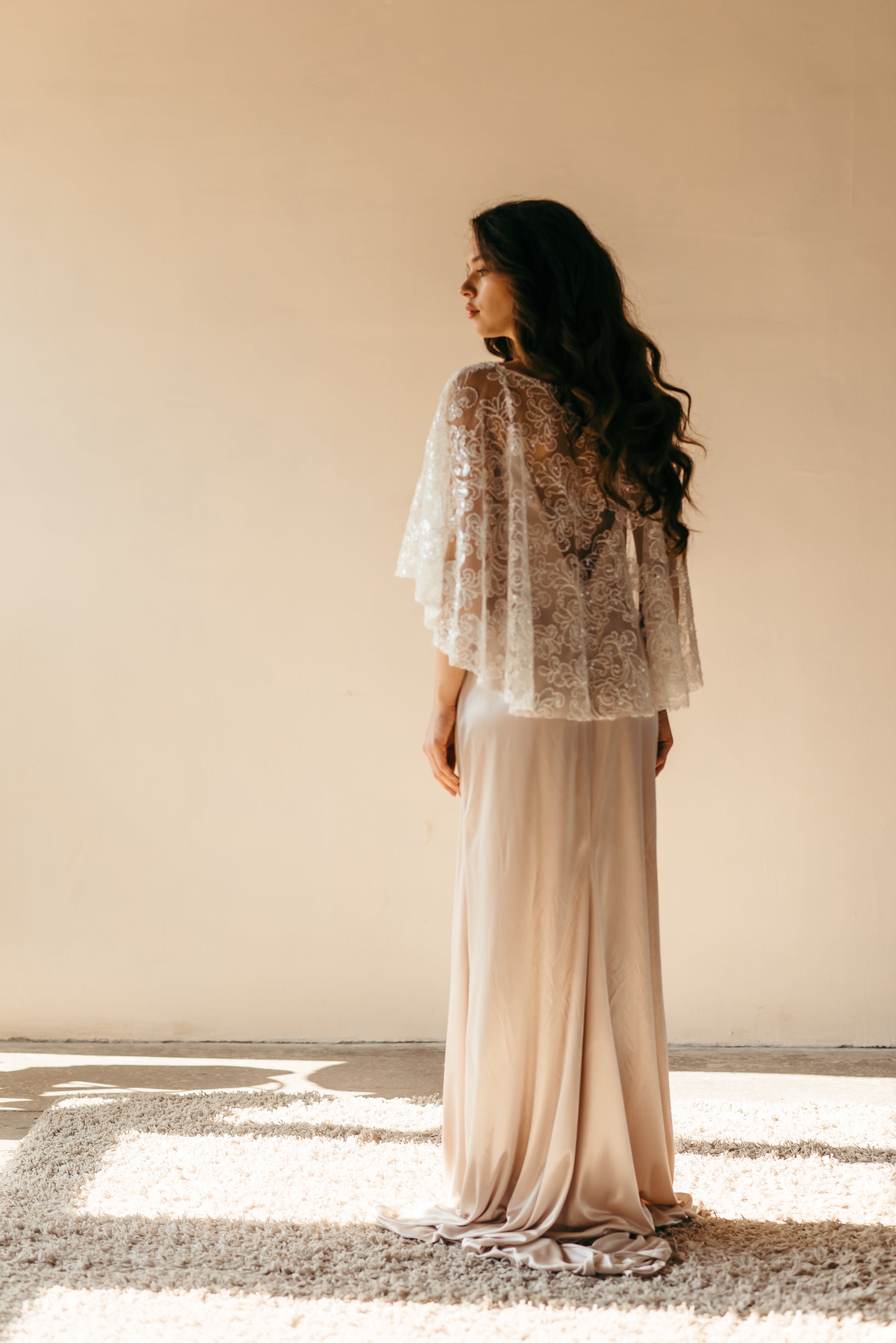 Bride wearing beaded sequined capelet, side profile