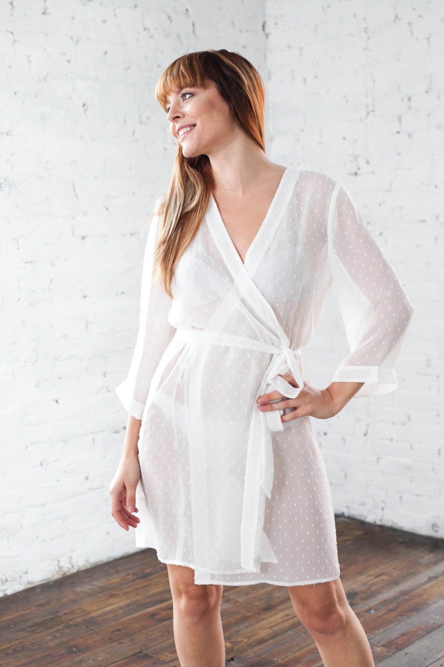 Bride wearing sexy sheer bridal robe at her honeymoon