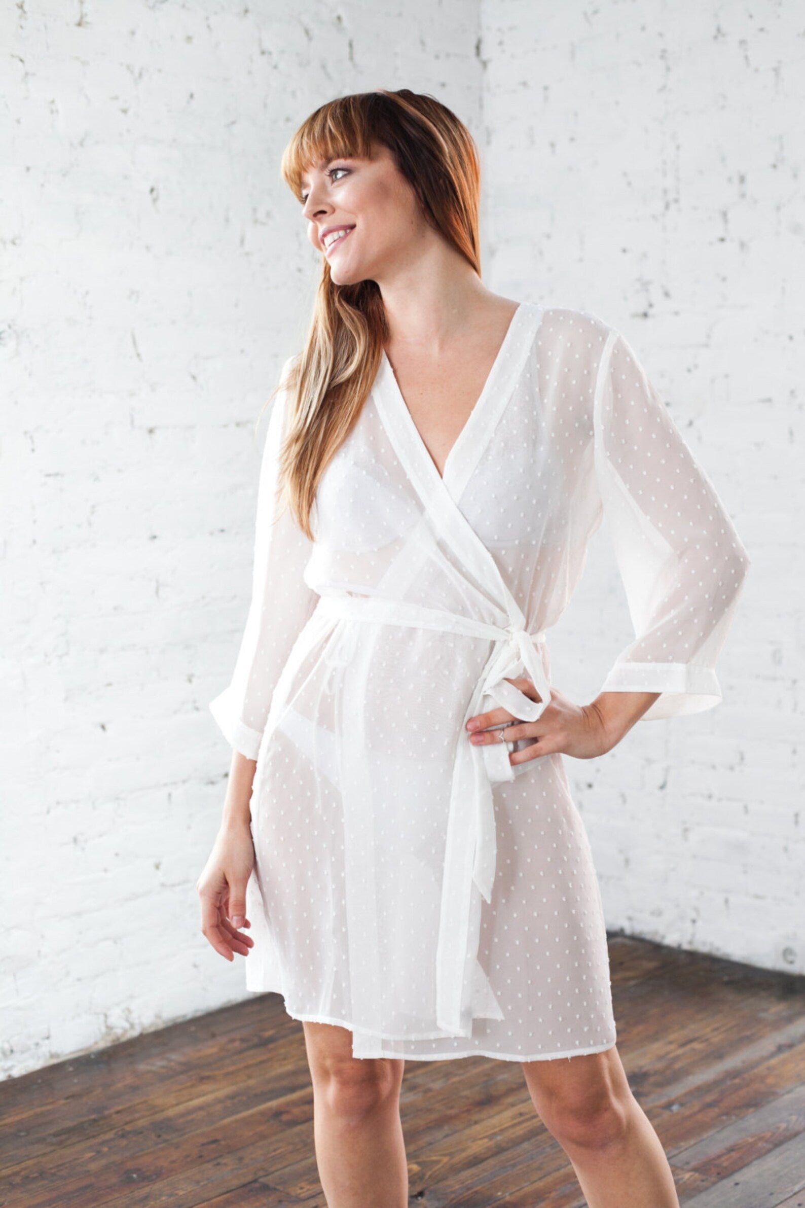 Bride wearing sexy sheer bridal robe at her honeymoon