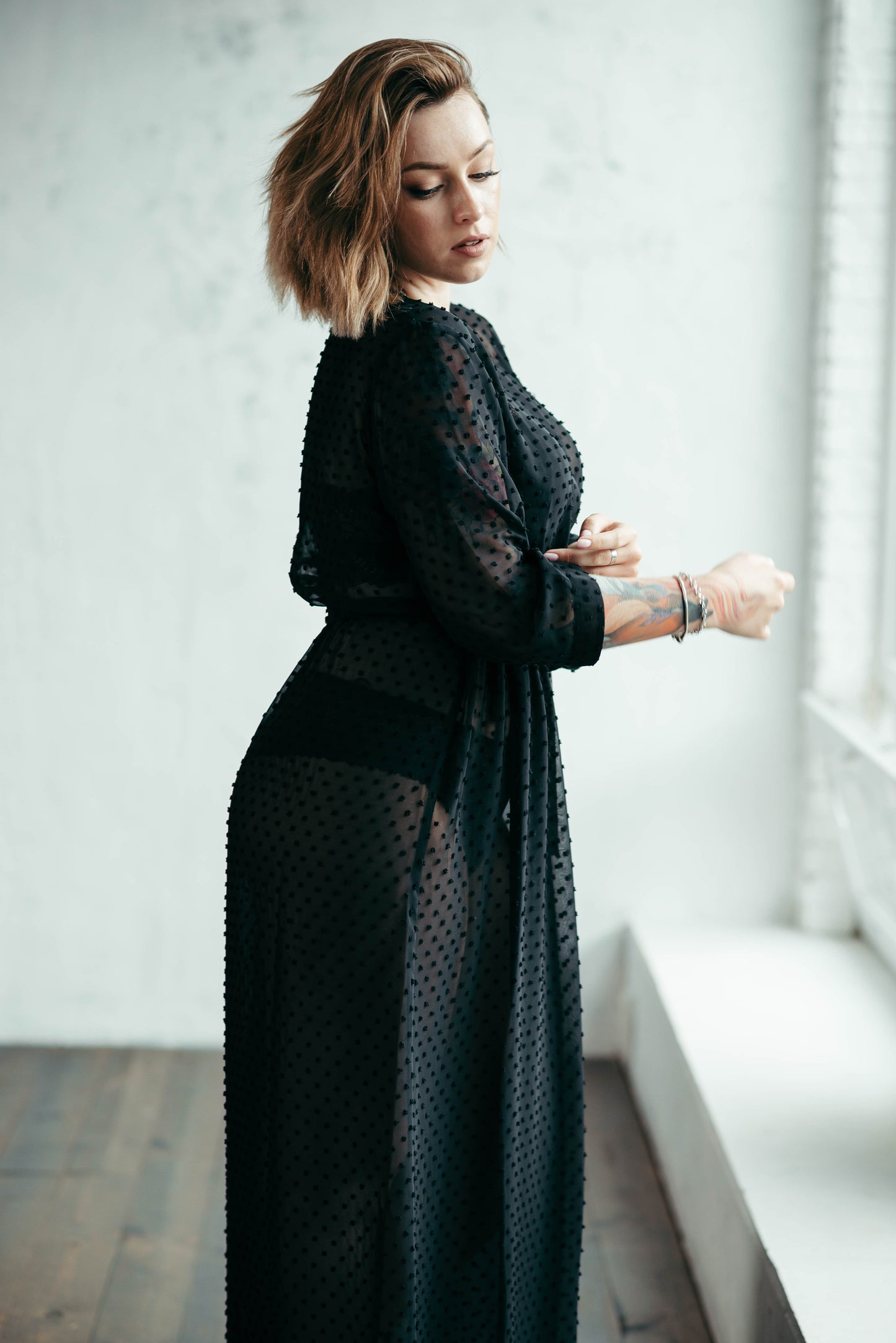 Black sheer polka dot robe, side view by window
