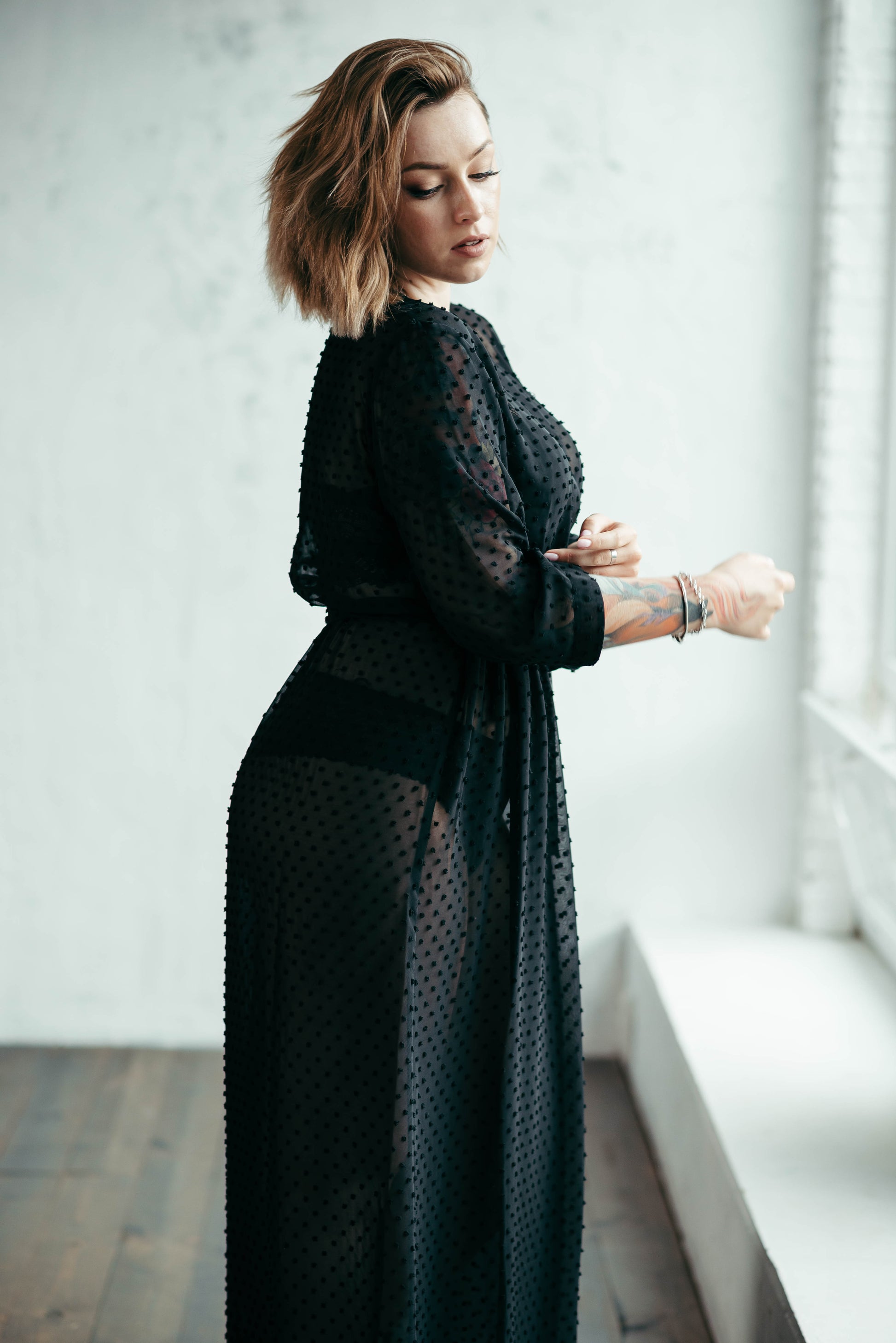 Black sheer polka dot robe, side view by window