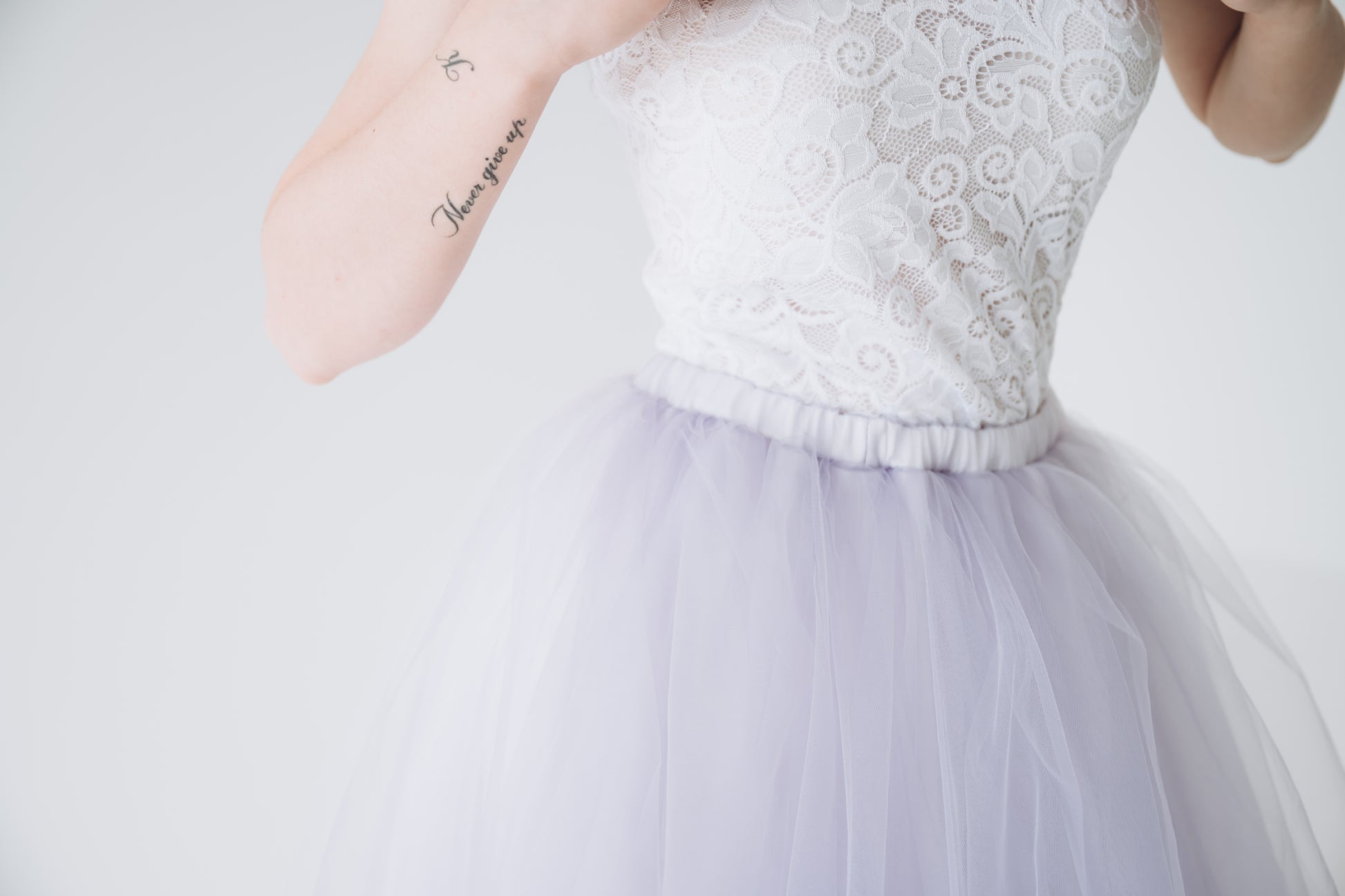 Lace bridal top styled with lavender tulle skirt, close up